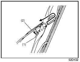 2) Squeeze lock lever (1) towards wiper